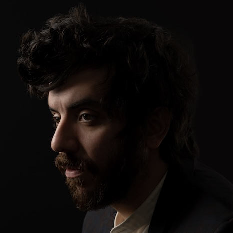 profile of Kaveh Akbar against black background
