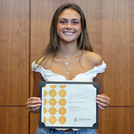 Isabella Benson holding her award