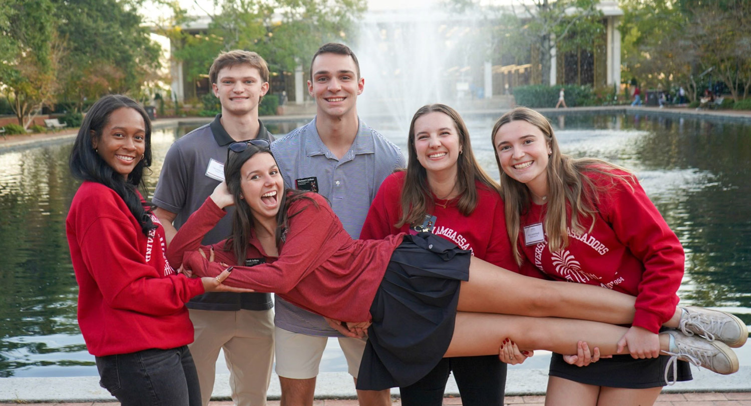 Group of ambassadors in front of library fountain