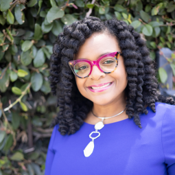 Dr. Shaneen Dials Corujo and Gregory Glover with framed photo of Adrenee Glover Freeman