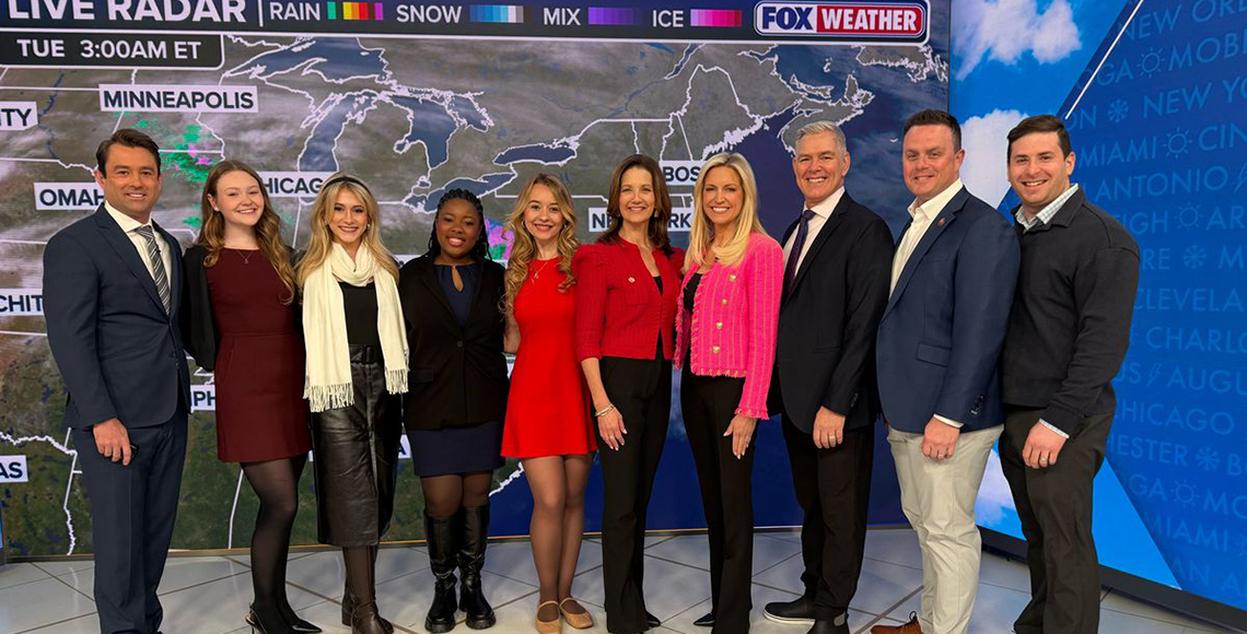 CIC faculty, staff and students standing in front of the Fox News screen in NYC