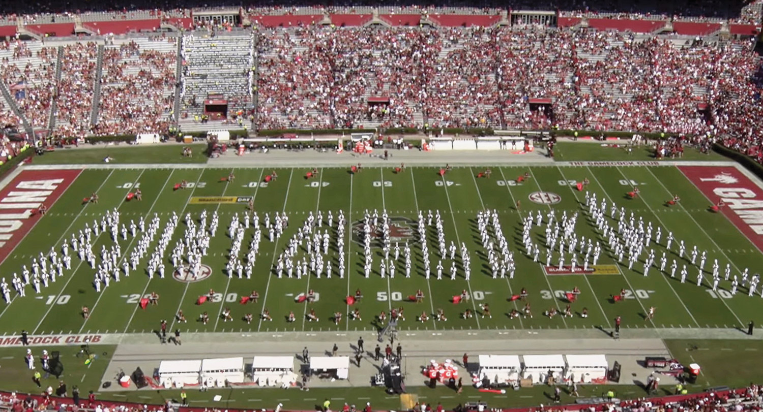 The Carolina Marching Band forms of the Metallica logo on the football field at Williams Brice stadium.
