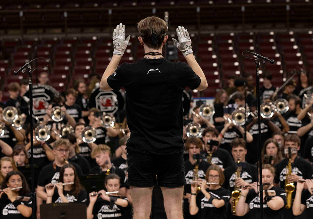 The Carolina Band drum major leads the band at Colonial Life Arena.